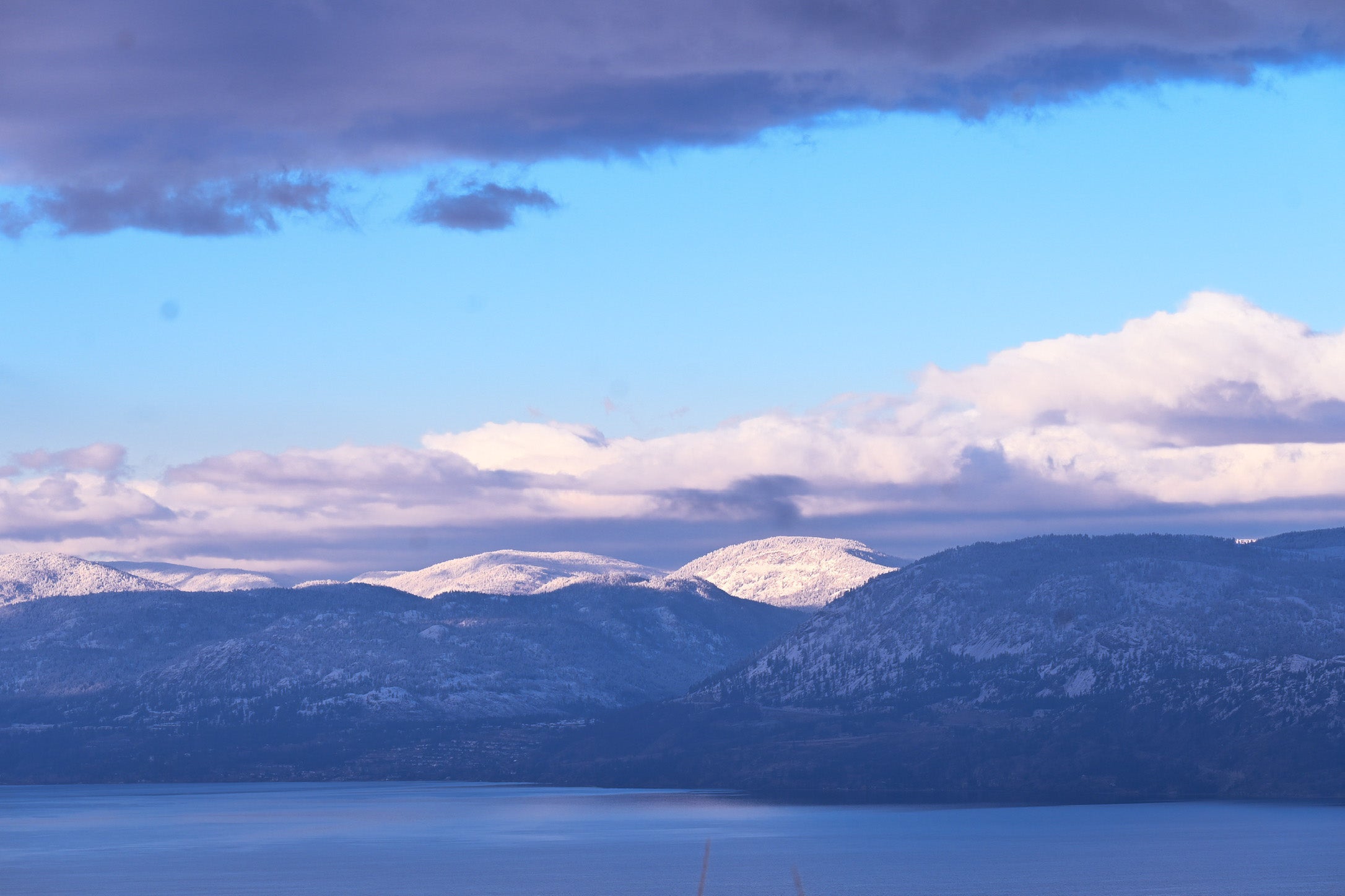 Snow on the hills above Okanagan Lake on a clear winter morning