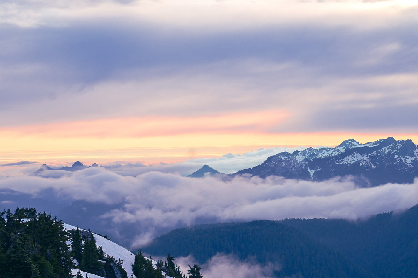 Peaks standing above a sea of cloud at sunset