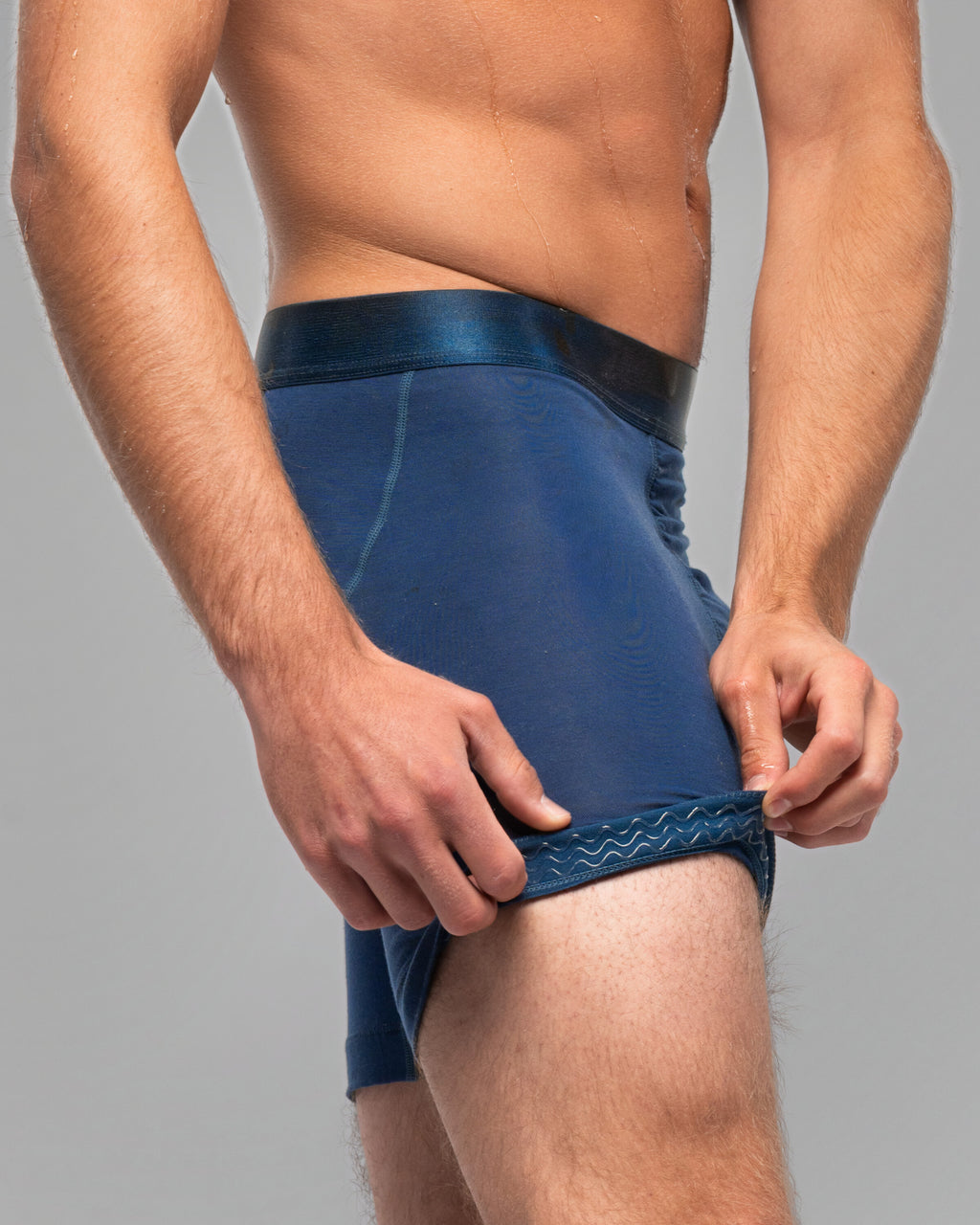 [Abyss 5] Nether Roam Boxer Brief in navy, leg hem turned back to show the Trail Grip silicone band inside