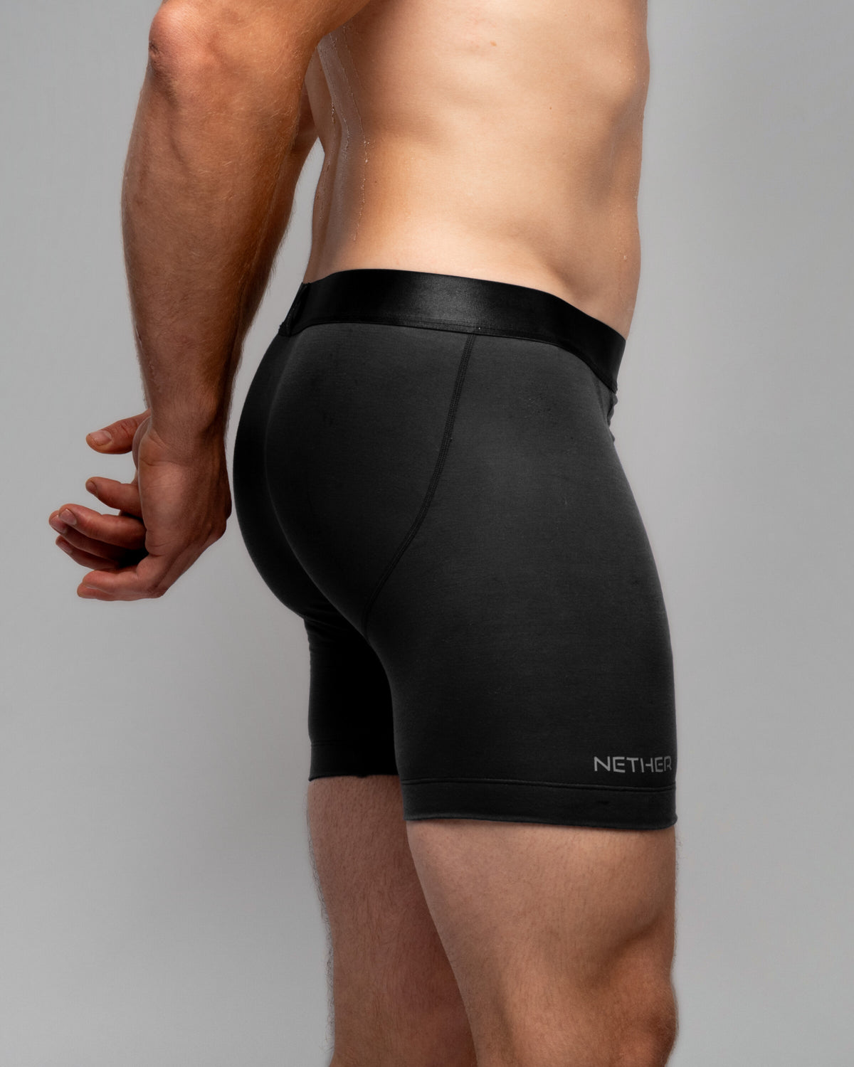 [Midnight 6] Nether Roam Boxer Brief in black, rear three-quarter waist-down view showing the side seam
