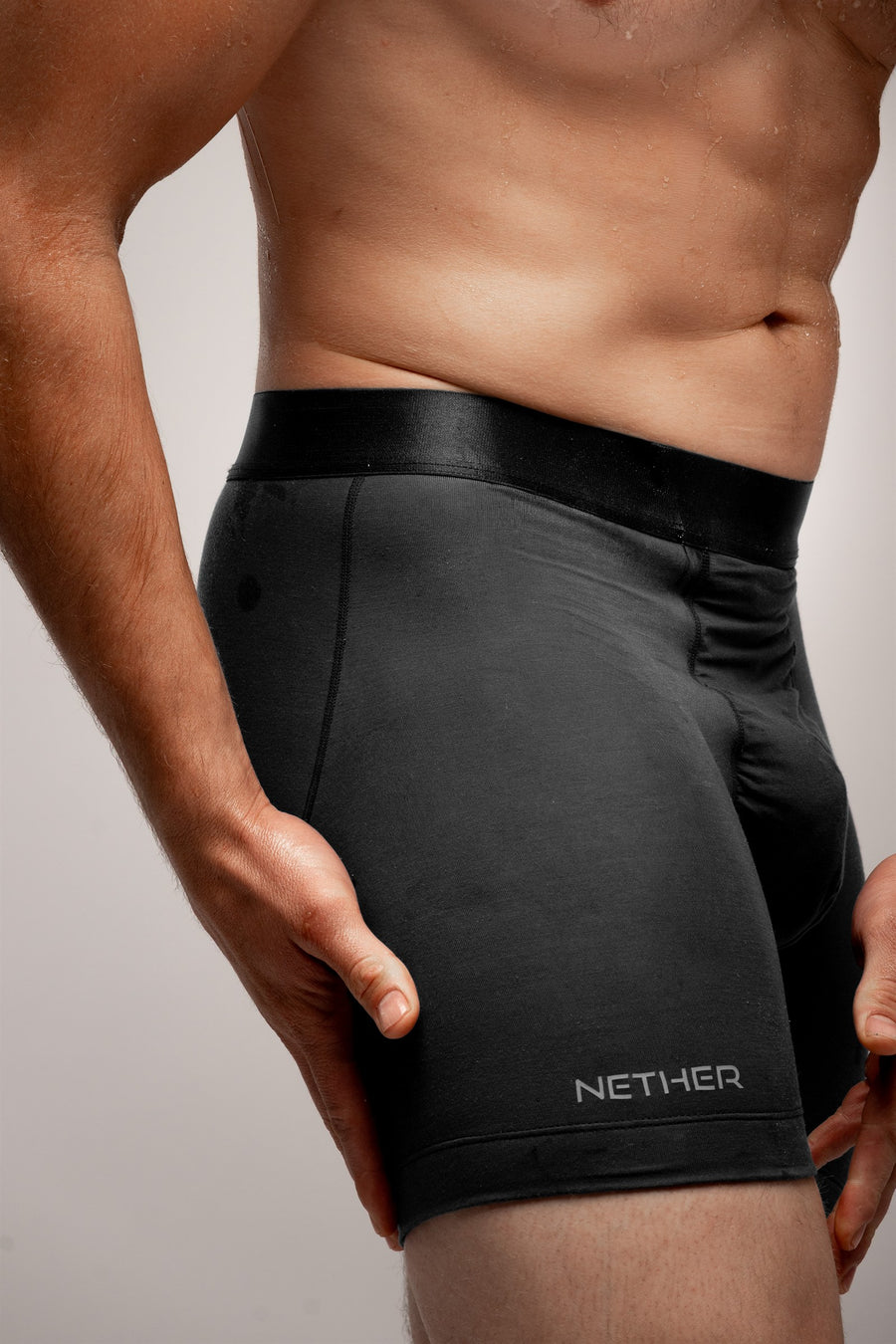 [Midnight] Nether Roam Boxer Brief in black, close detail of the satin waistband, side seam and NETHER leg print