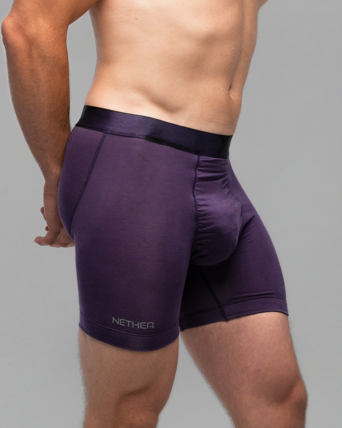 [Storm 4] Nether Roam Boxer Brief in dark purple, three-quarter waist-down view showing the NETHER leg print