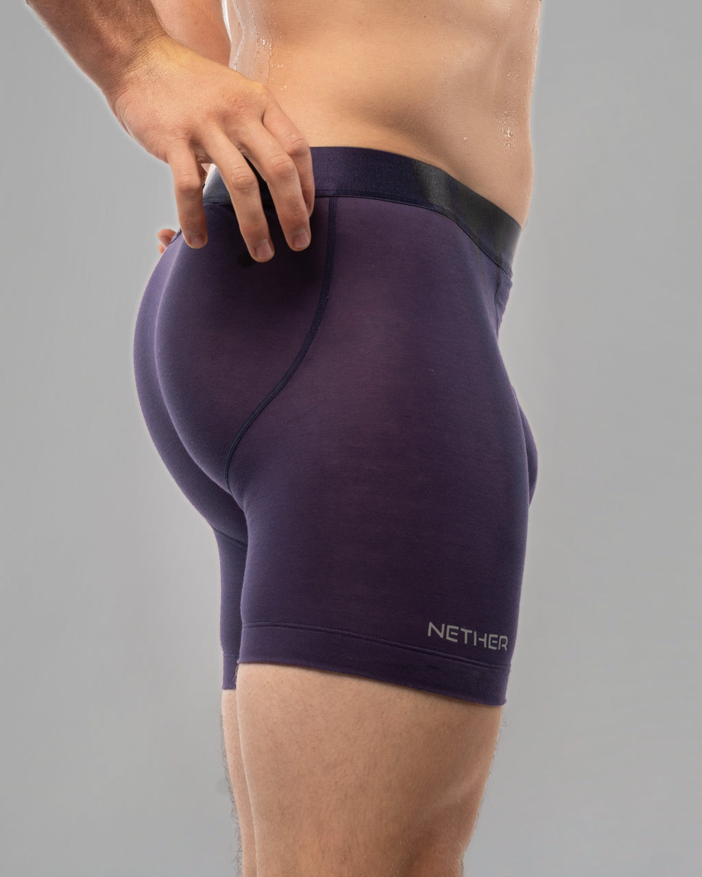 [Storm 6] Nether Roam Boxer Brief in dark purple, rear three-quarter view showing the contoured seat