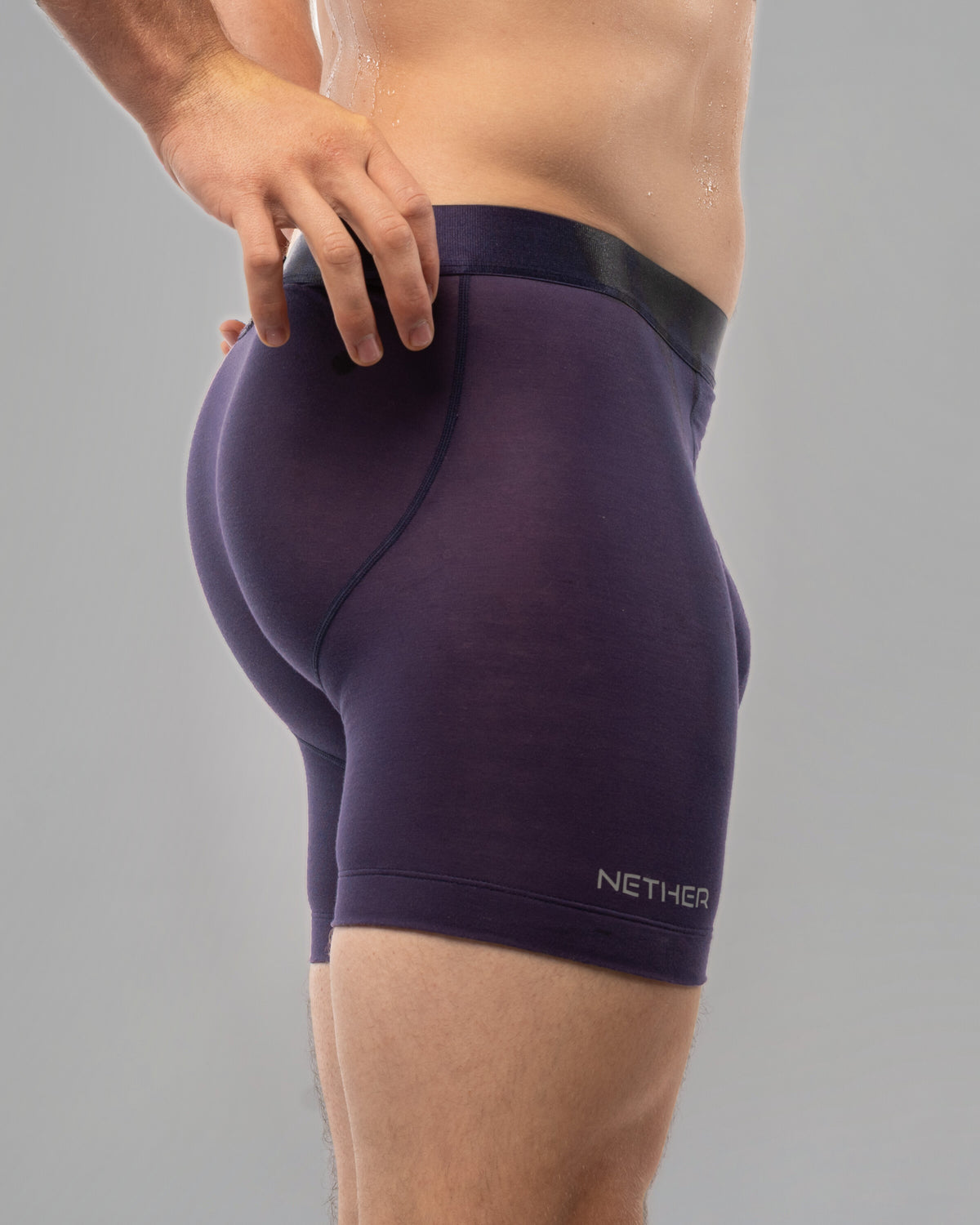[Storm 6] Nether Roam Boxer Brief in dark purple, rear three-quarter view showing the contoured seat
