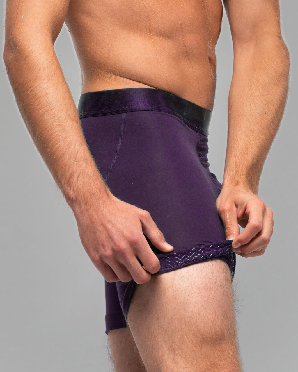 [Storm 5] Nether Roam Boxer Brief in dark purple, leg hem turned back to show the Trail Grip silicone band inside